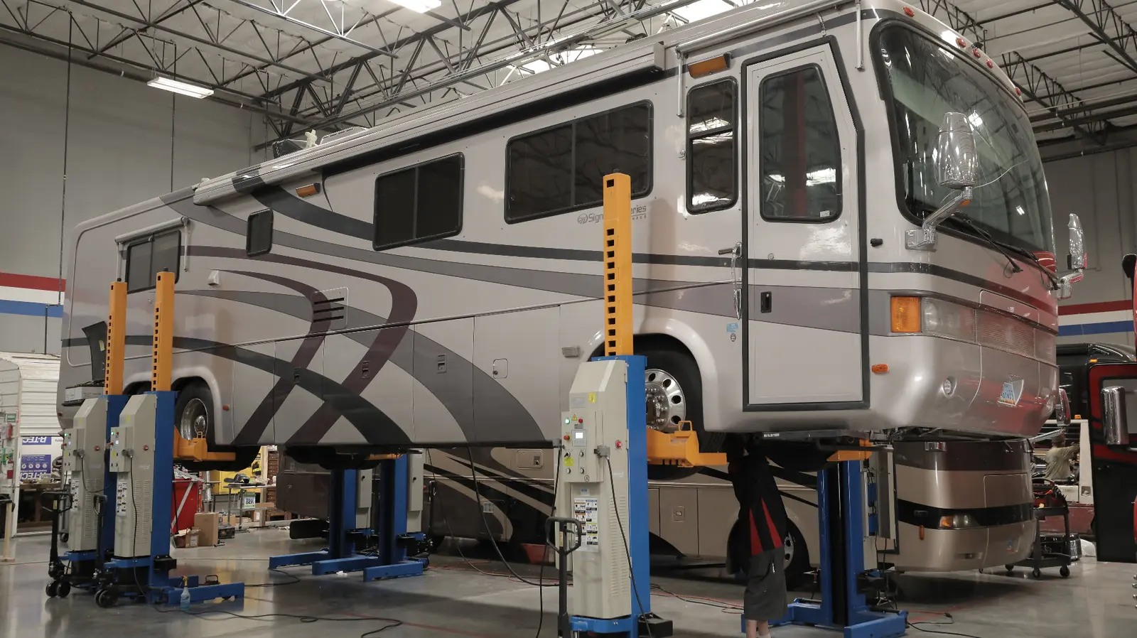 Motorcoach on hydraulic lifts in service bay