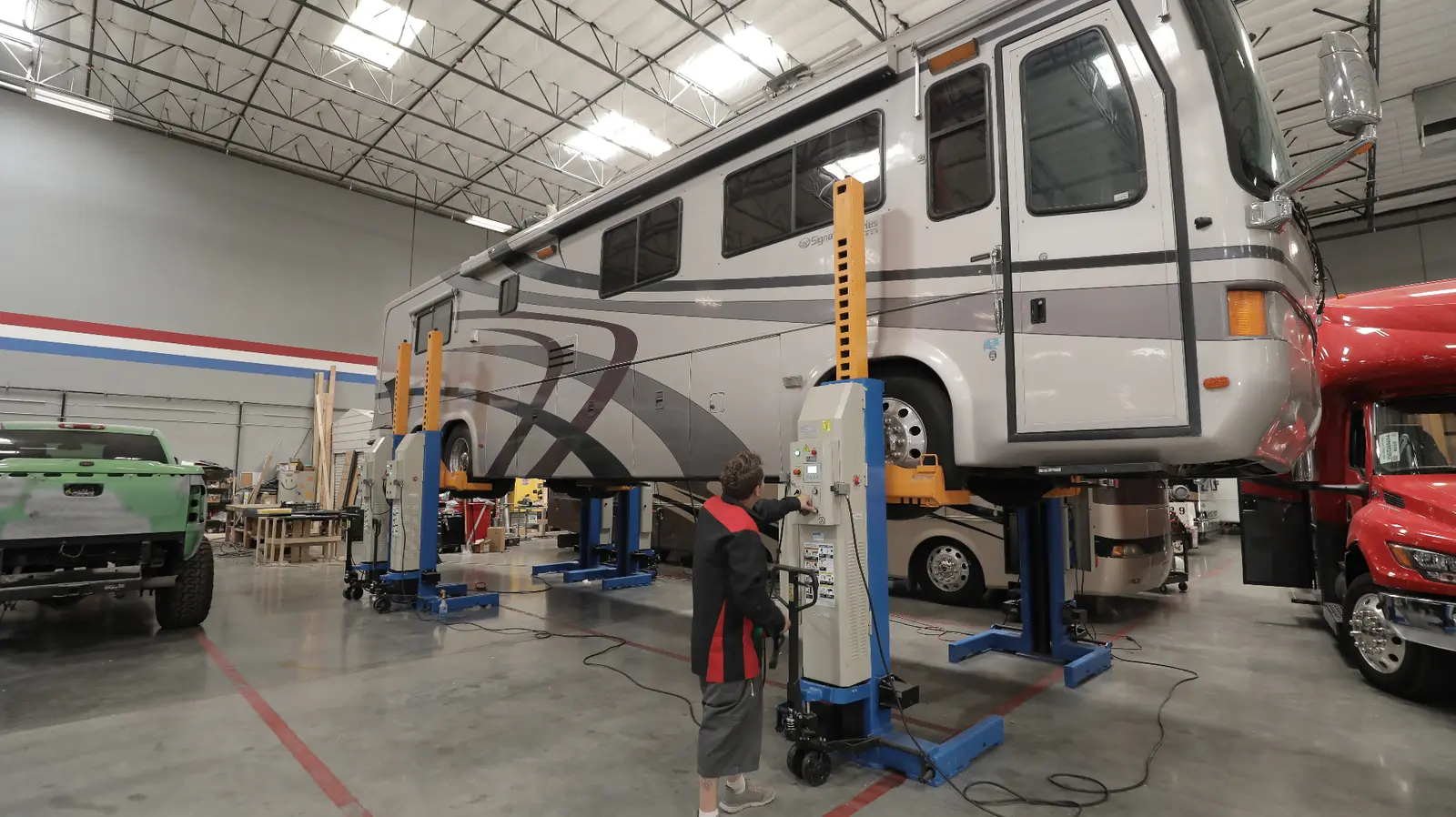 Technician working on motorcoach in shop